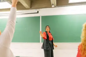 woman standing in front of blackboard - featured image