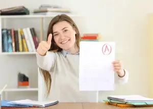 graduate showing exam score - featured image